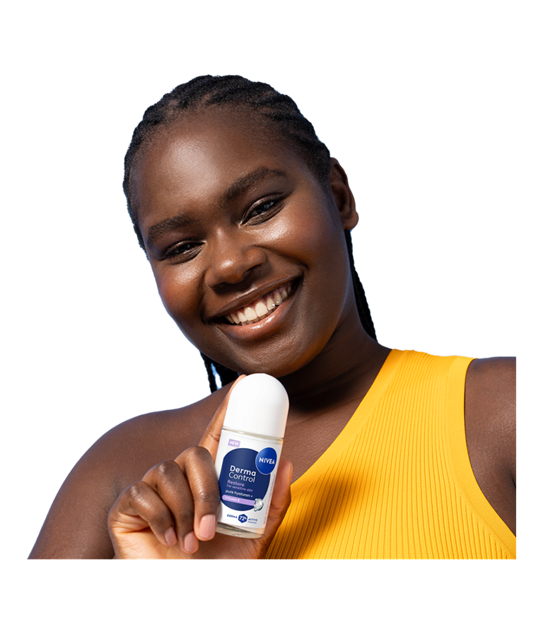 A young smiling woman tilts her head while holding up NIVEA Derma Control Restore Deo Roll-On.