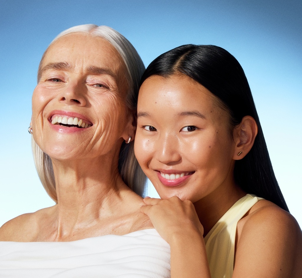 a young woman and an old lady smiling to the camera