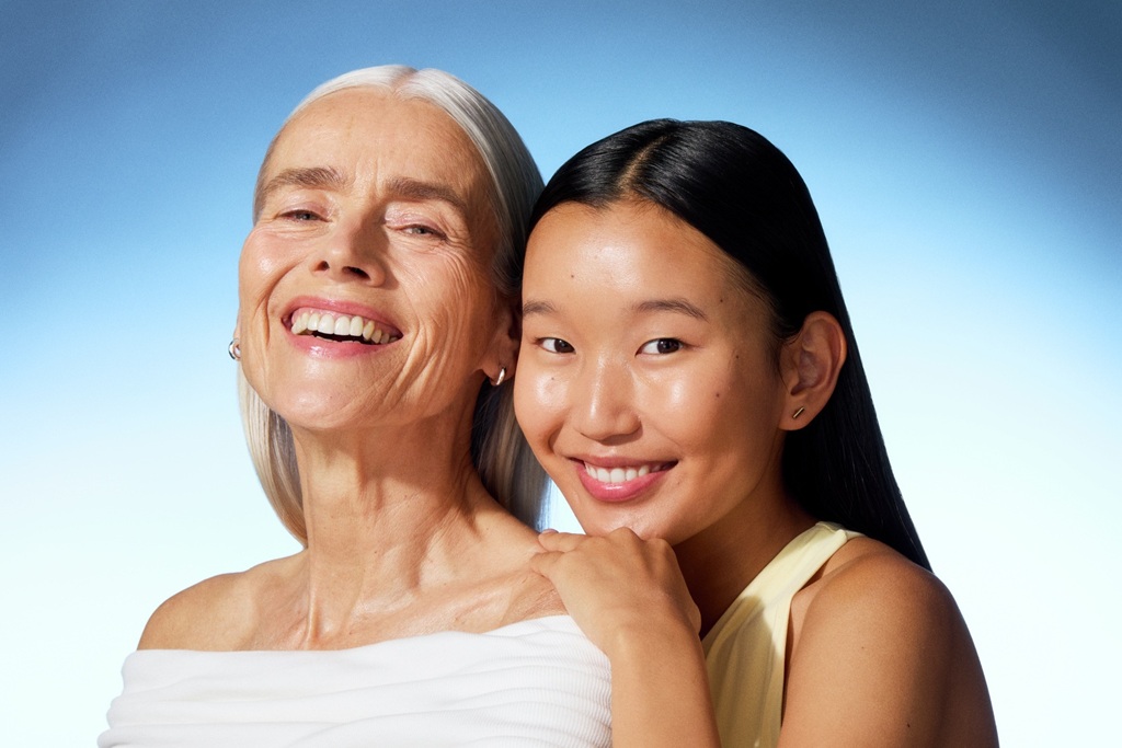 a young woman and an old lady smiling to the camera