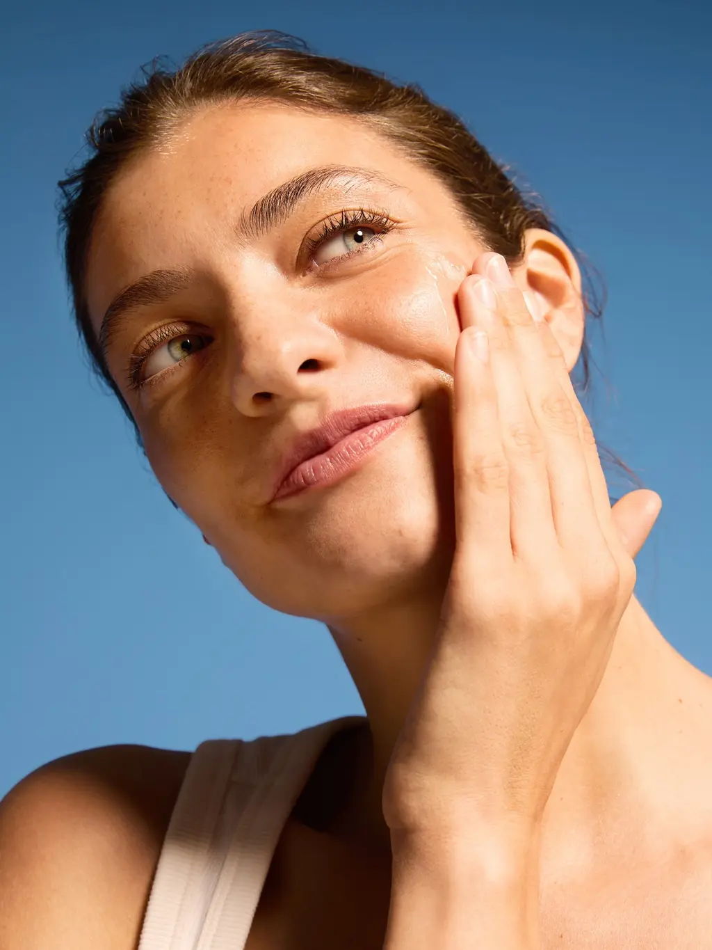Young woman touching her face