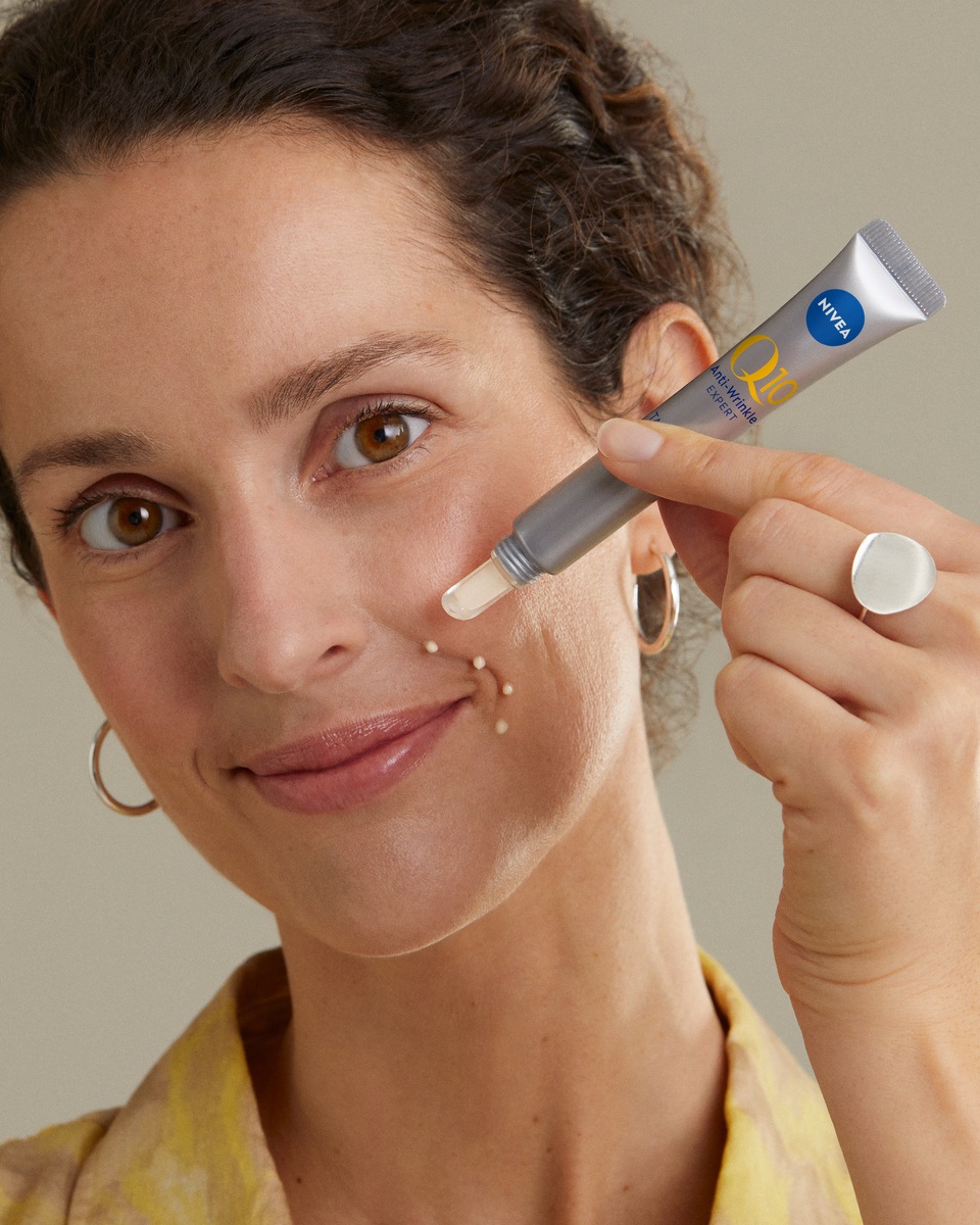 woman using Nivea Q10 anti-wrinkle serum