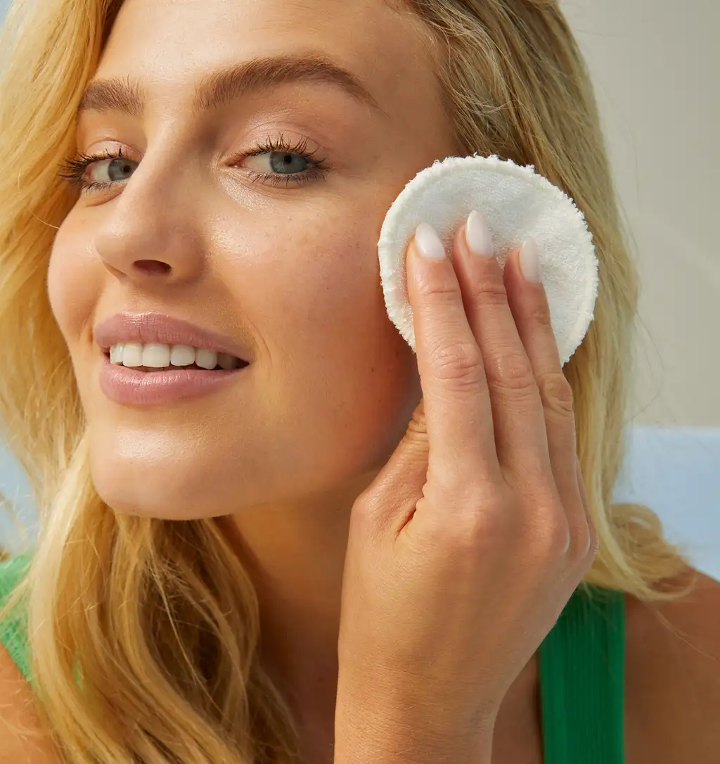 Young woman cleaning her face