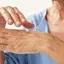 hands of an old person with some serum on it