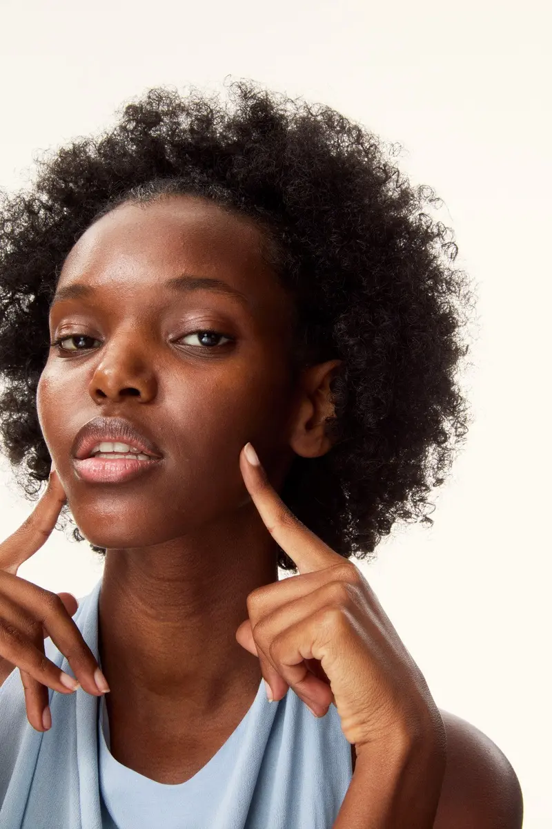 Young woman applying Nivea sun lotion