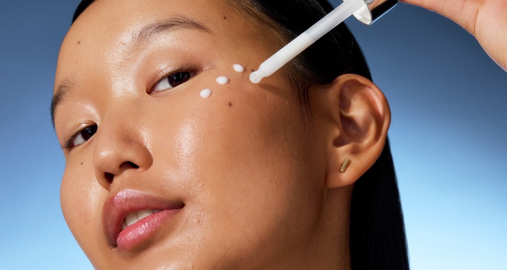 young woman applying serum