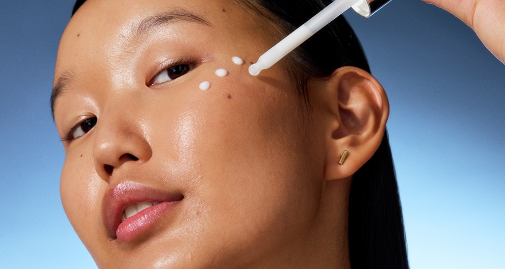 young woman applying serum