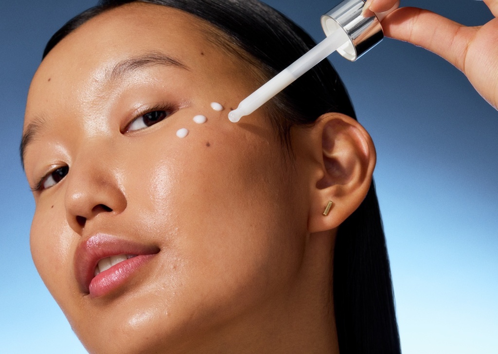 young woman applying serum
