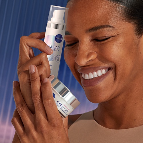A woman, holding up two products of NIVEA Epigenetics serum and Day Care Cream.