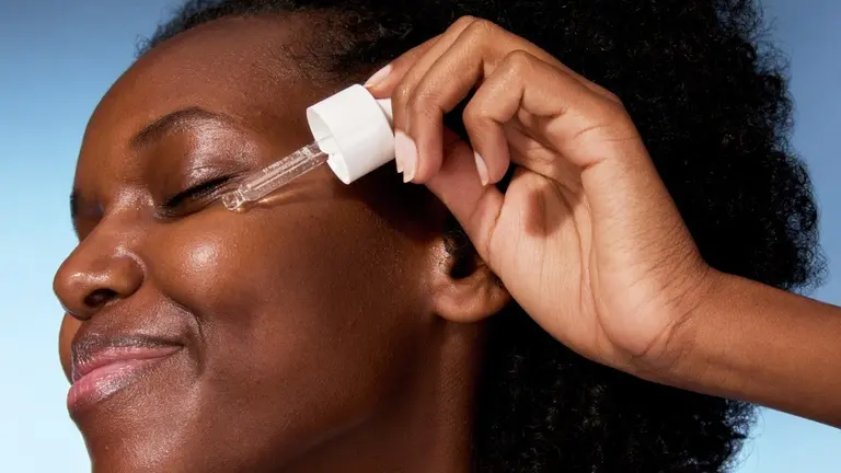 young woman applying serum