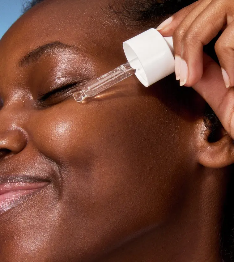 young woman applying serum