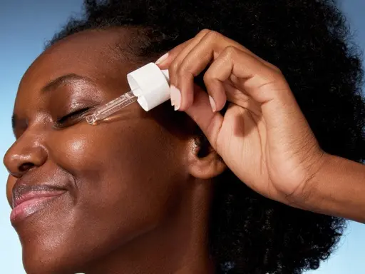 young woman applying serum