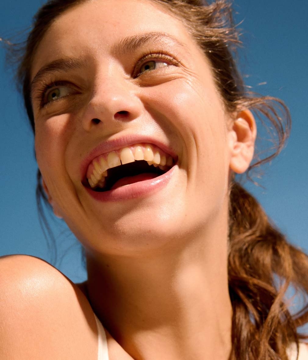 woman with clear skin laughing