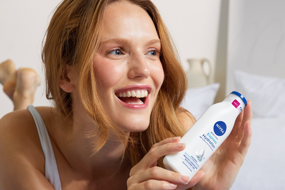 young woman using Nivea Express Hydration Body Lotion