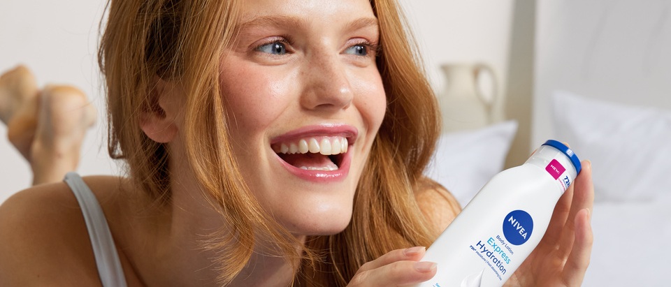 young woman using Nivea Express Hydration Body Lotion