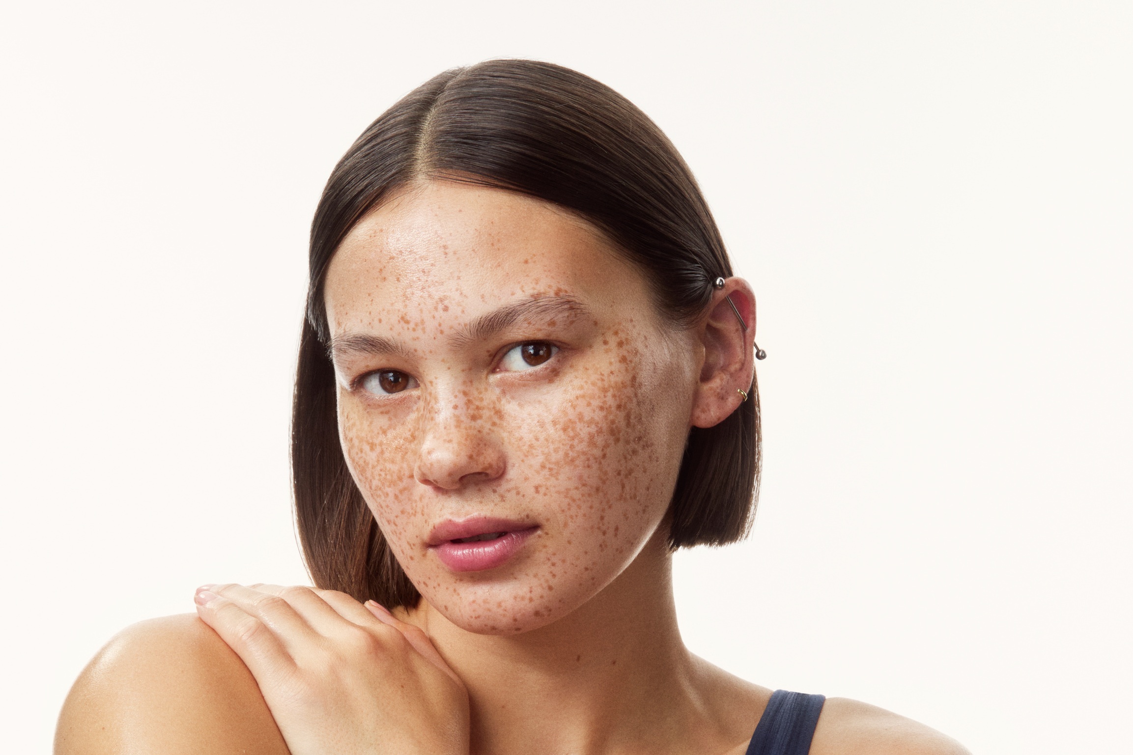 young girl in a top with creams all over her arms