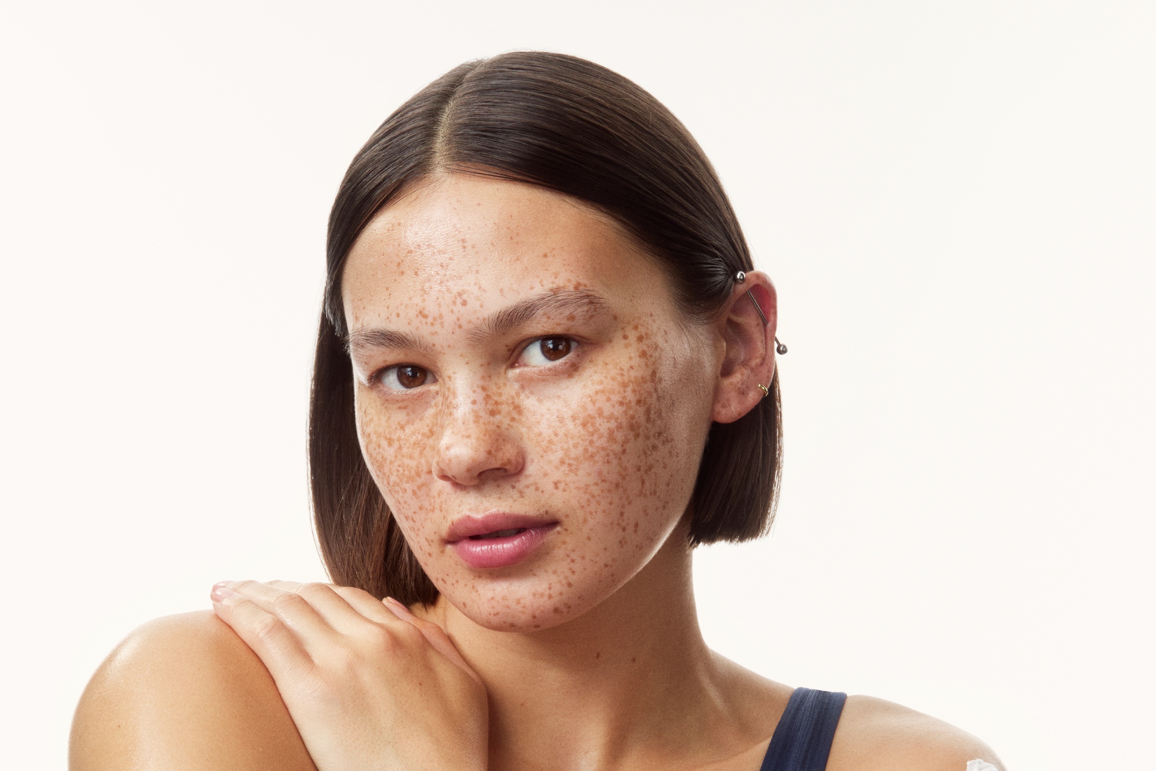 young girl in a top with creams all over her arms