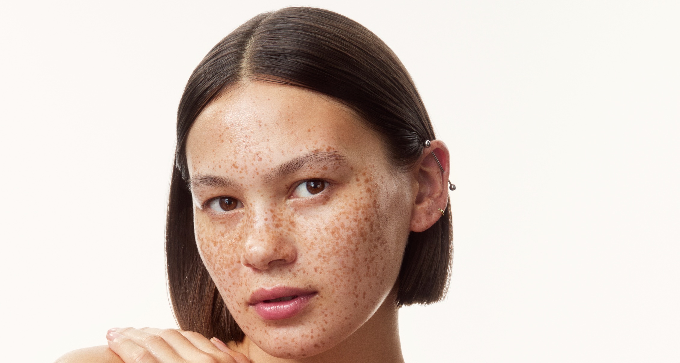 young girl in a top with creams all over her arms