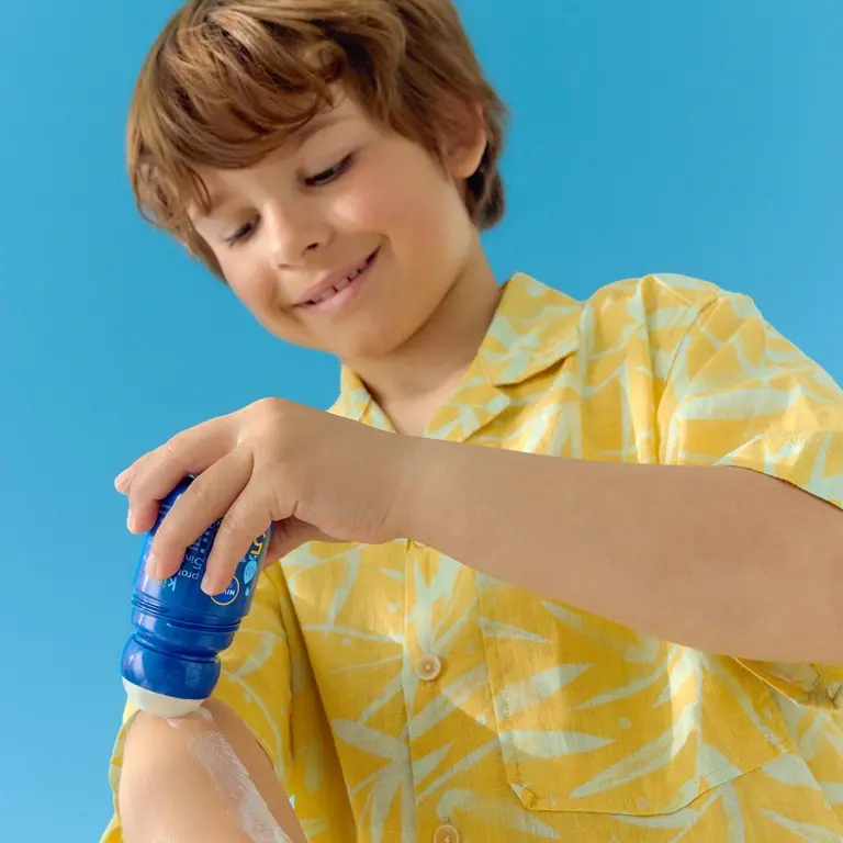 Woman and child applying sunscreen