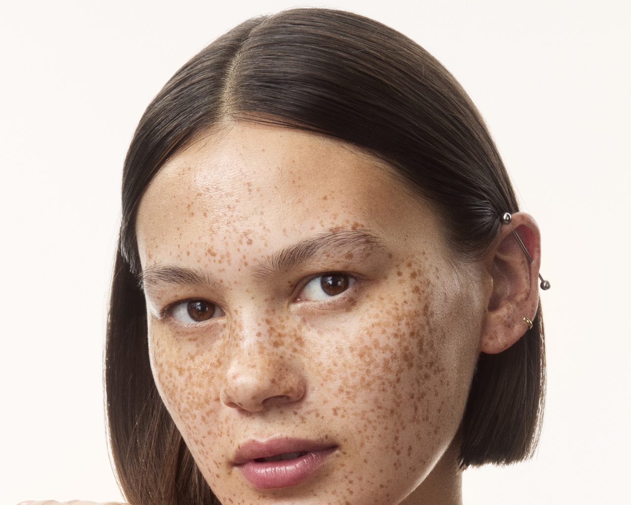 young girl in a top with creams all over her arms