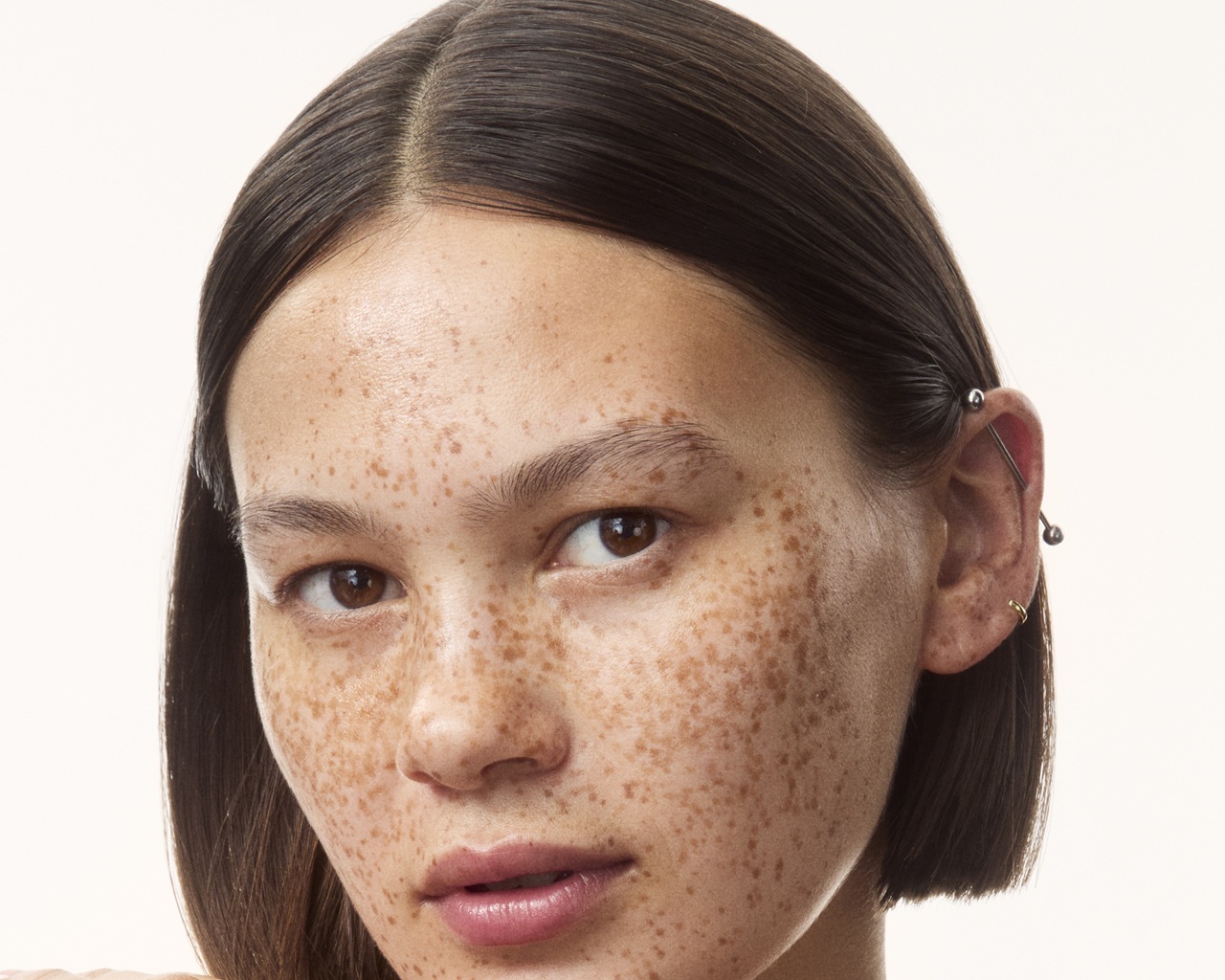 young girl in a top with creams all over her arms