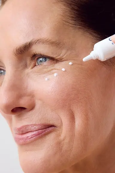 Woman using NIVEA Q10 Anti-Wrinkle POWER EXTRA FIRMING EYE CREAM