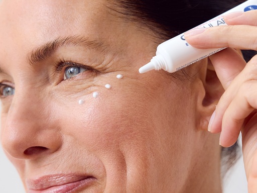 Woman using NIVEA Q10 Anti-Wrinkle POWER EXTRA FIRMING EYE CREAM