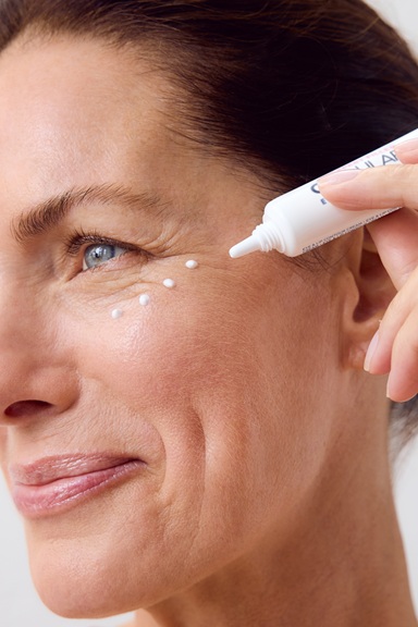 Woman using NIVEA Q10 Anti-Wrinkle POWER EXTRA FIRMING EYE CREAM