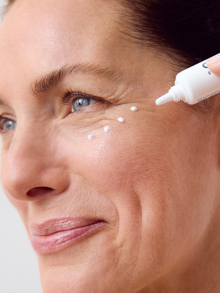Woman using NIVEA Q10 Anti-Wrinkle POWER EXTRA FIRMING EYE CREAM
