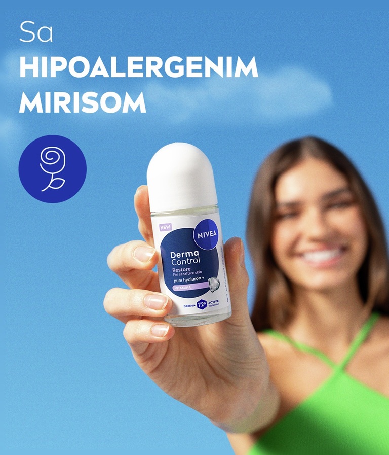 A blurred young woman smiles, with her hand in focus holding up the NIVEA Derma Control Restore Deo Roll-On.