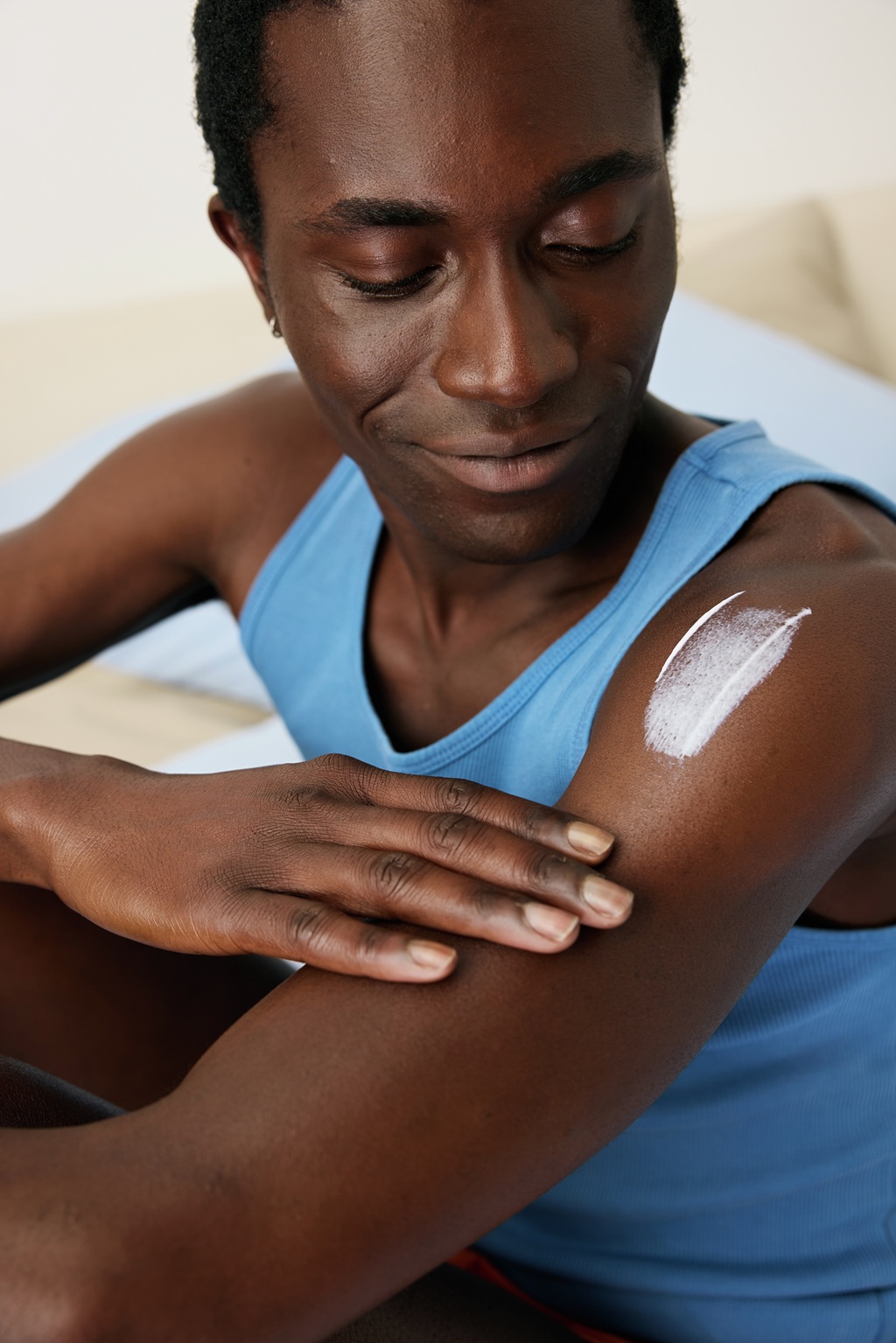 Young woman applying Nivea sun lotion