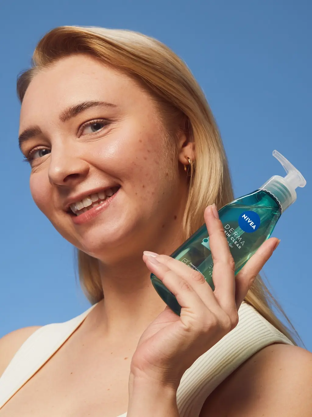 young woman using Nivea DermaSkin face cleanser