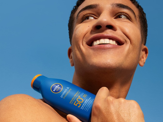 Young man using Nivea Protect & Moisture Lotion spf50+