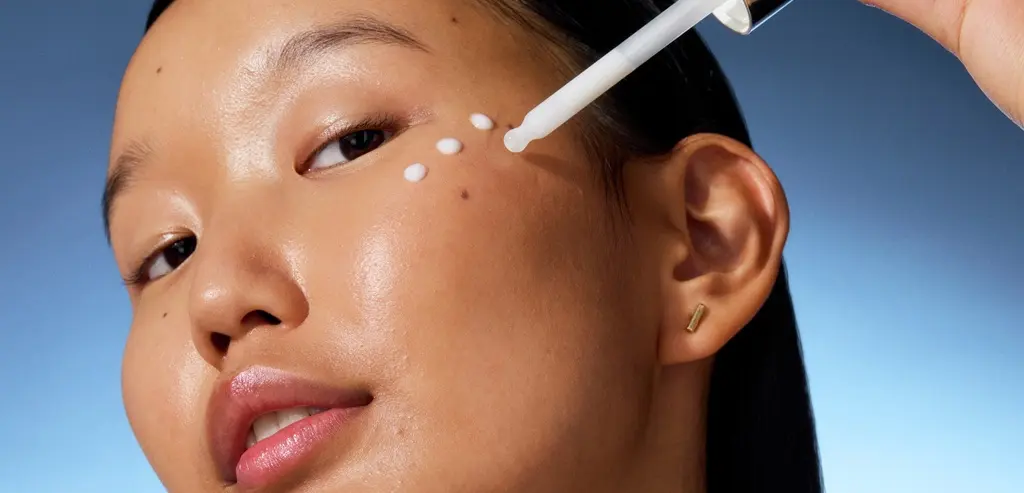Blonde hair woman using Nivea Q10 Anti Wrinkle face cream