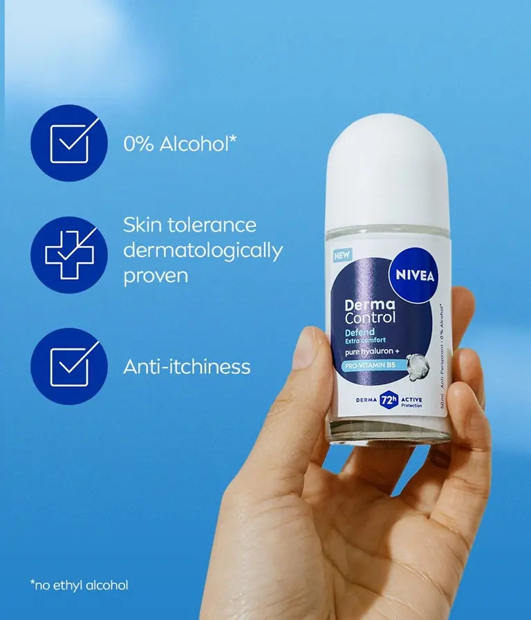 A hand holds up the NIVEA Derma Control Defend Deo Roll-On against a sky background