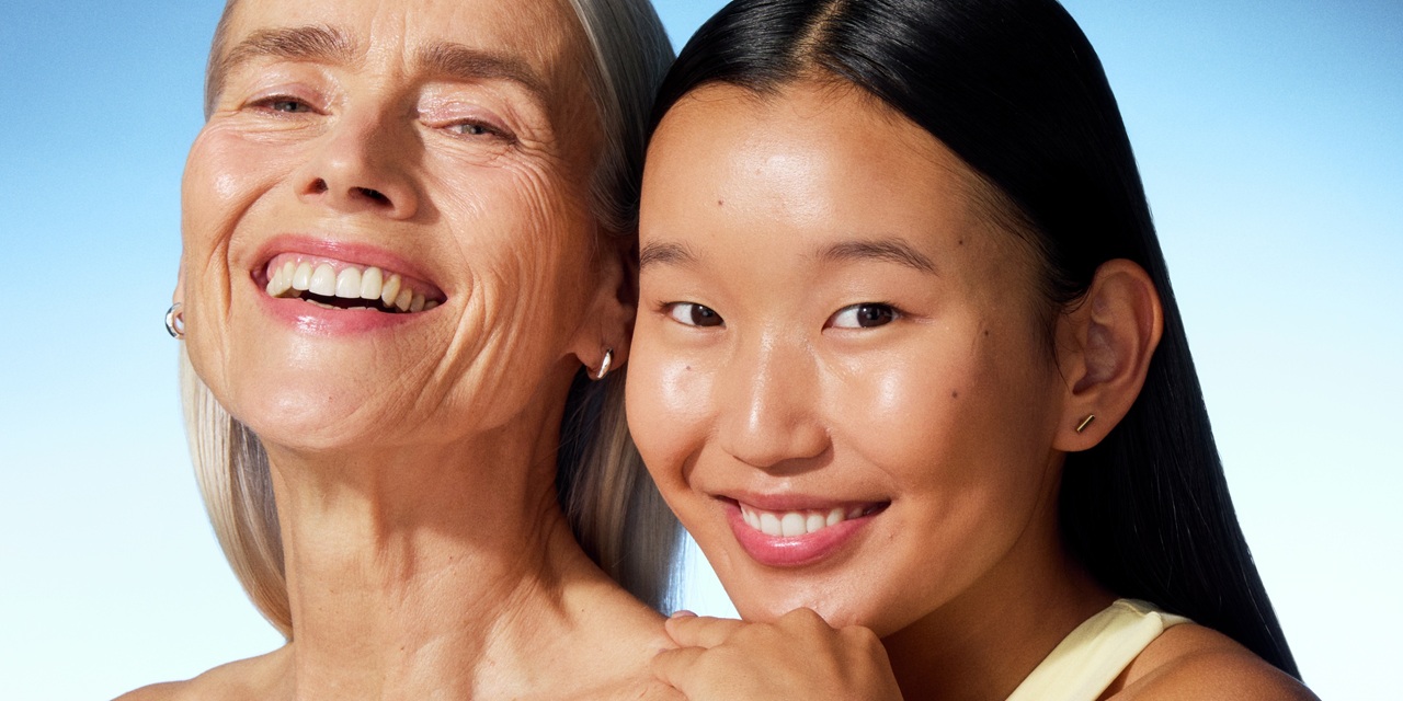 a young woman and an old lady smiling to the camera