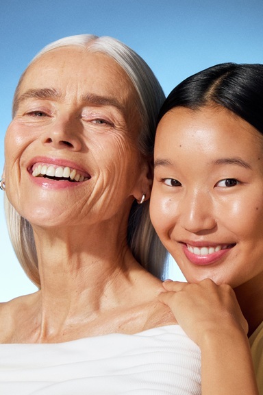 a young woman and an old lady smiling to the camera
