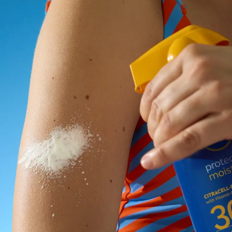 Woman applying sunscreen