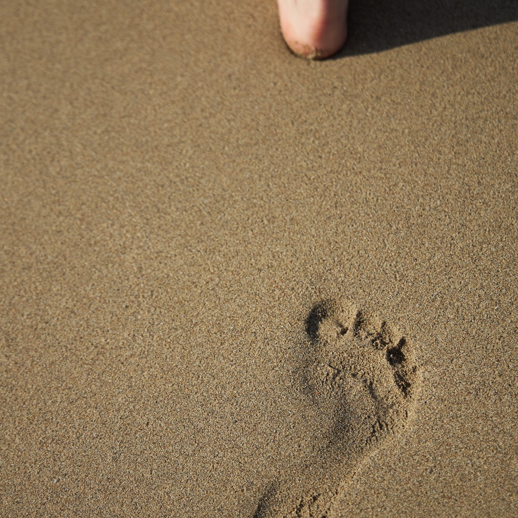 Clear footprints on the sandy ground at the beach