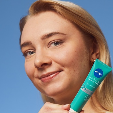 young woman using NIVEA Derma Skin Exfoliator