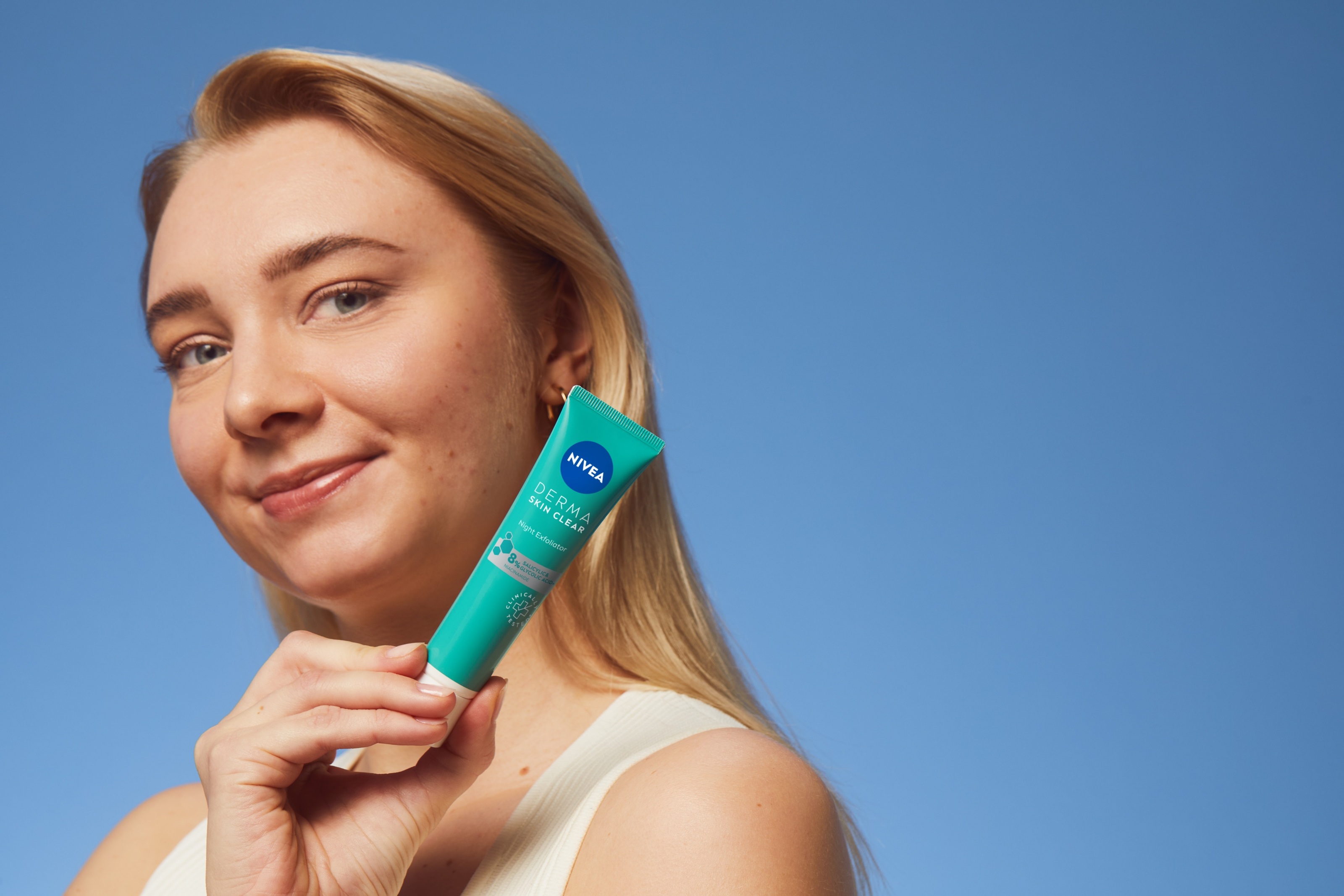 young woman using Nivea Derma Skin Exfoliator