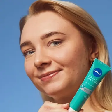 young woman using NIVEA Derma Skin Exfoliator