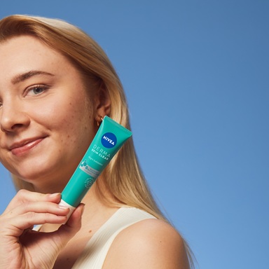 young woman using NIVEA Derma Skin Exfoliator