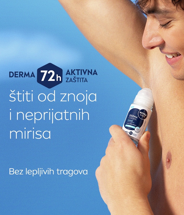 A young man smiles while lifting his arm and applying NIVEA MEN Derma Control Defend Deo Roll-On.