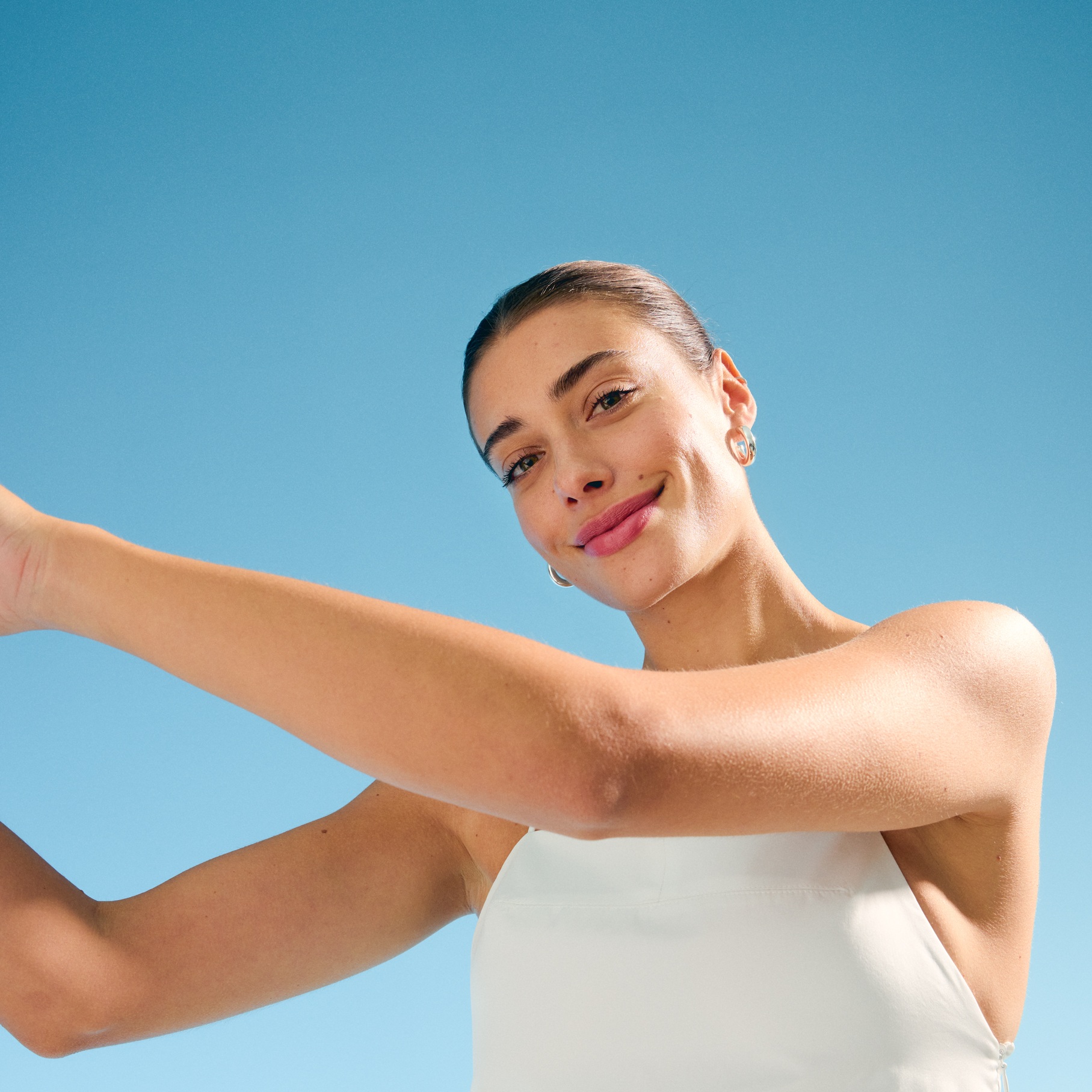 young woman standing in the sun