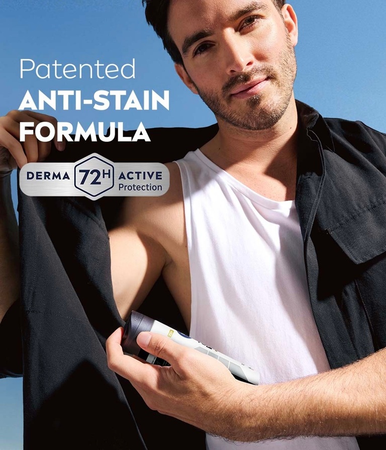 Man in a black shirt applying NIVEA MEN Black & White Epic Night deodorant spray, demonstrating its patented anti-stain formula and 72-hour active protection.