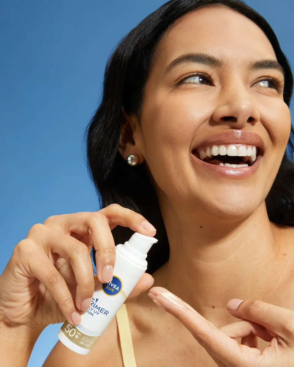 young woman using Nivea Prime 2in1 UV