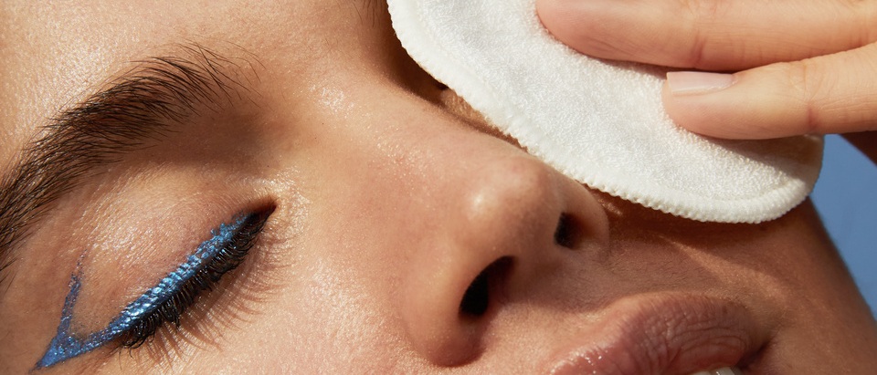 young woman taking her make up off
