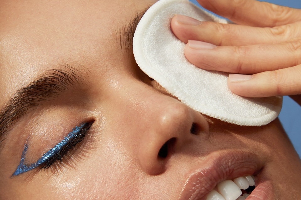 young woman taking her make up off