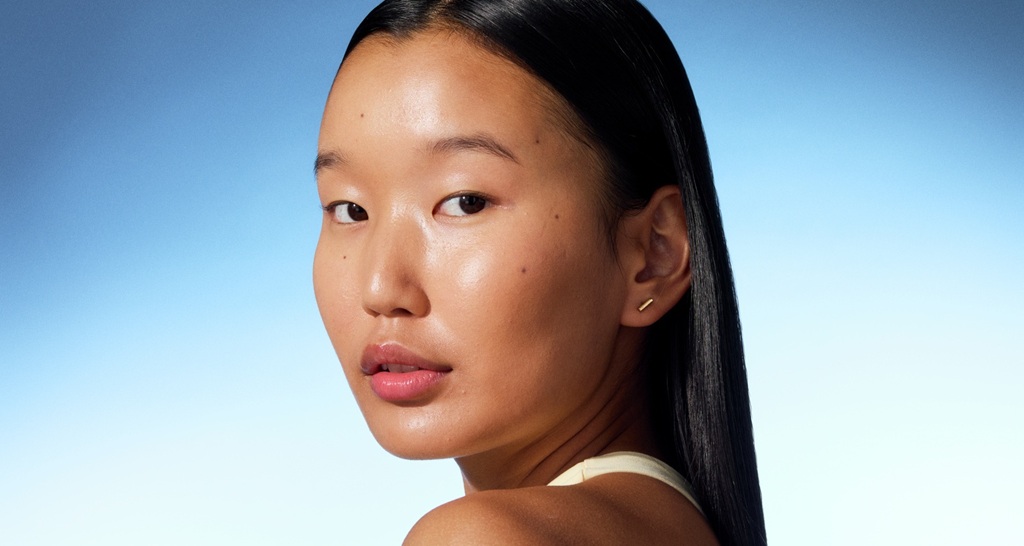a young girl looking into the camera with shiny skin