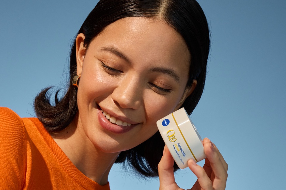 Woman using NIVEA Q10 Anti-Wrinkle POWER EXTRA FIRMING EYE CREAM